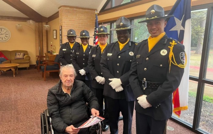 A veteran receiving recognition from an honor guard.