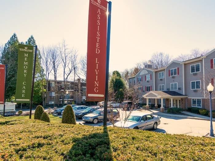 An assisted living facility with a parking lot on a sunny day.