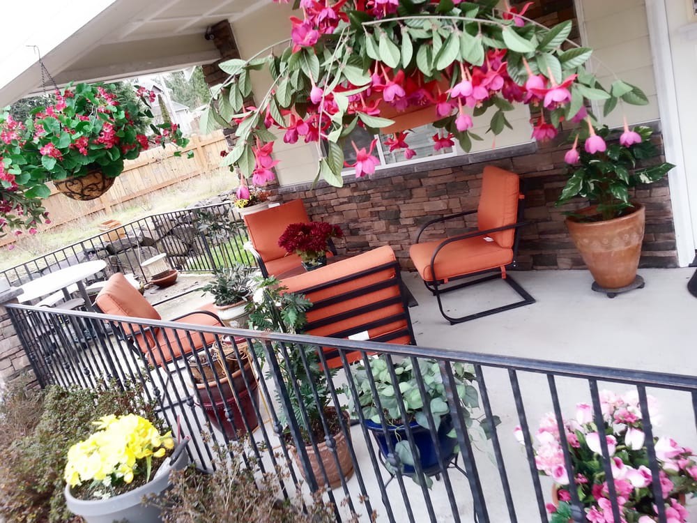 A charming patio adorned with vibrant flowers and comfortable seating.