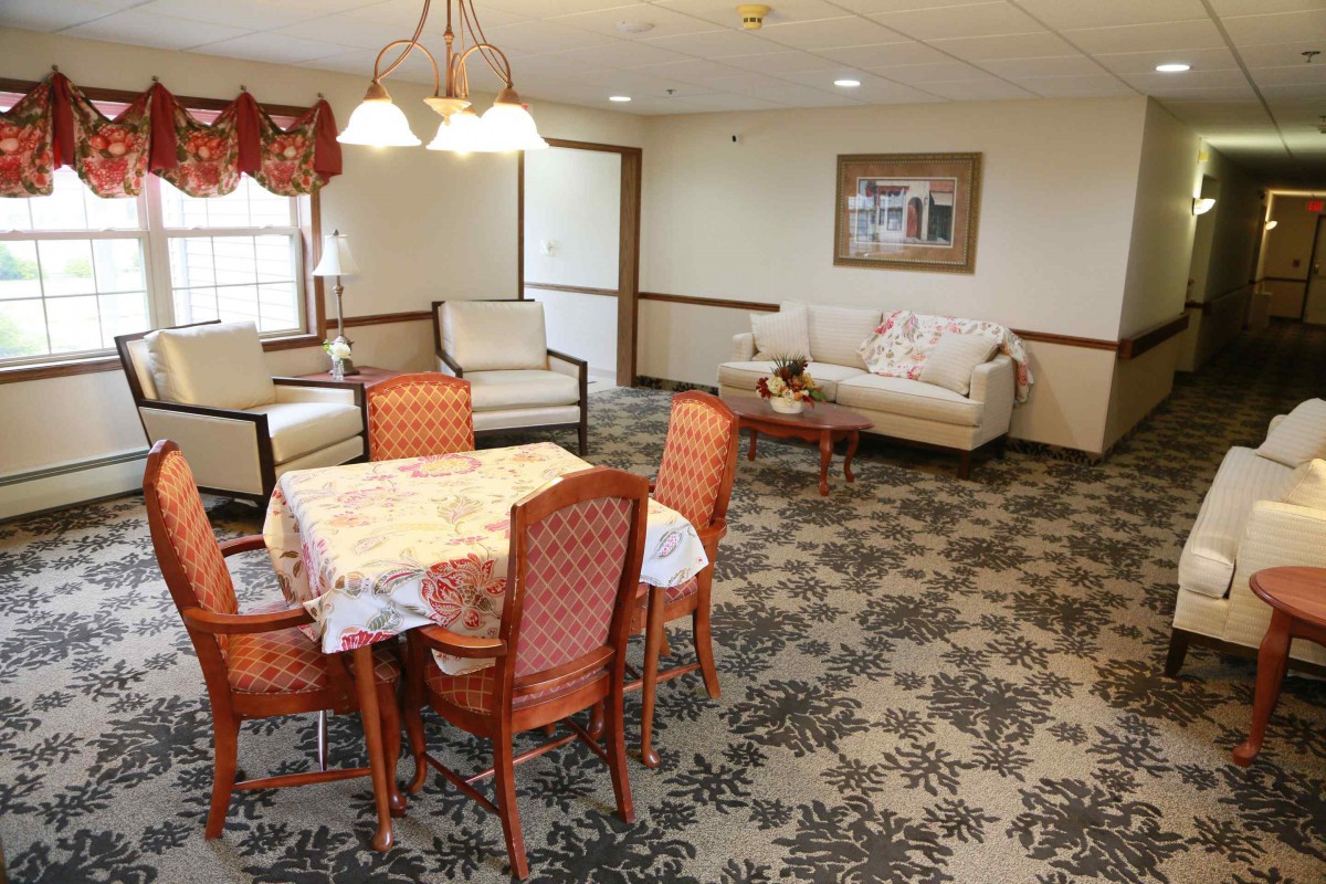 A cozy living room with a dining table and comfortable seating area.