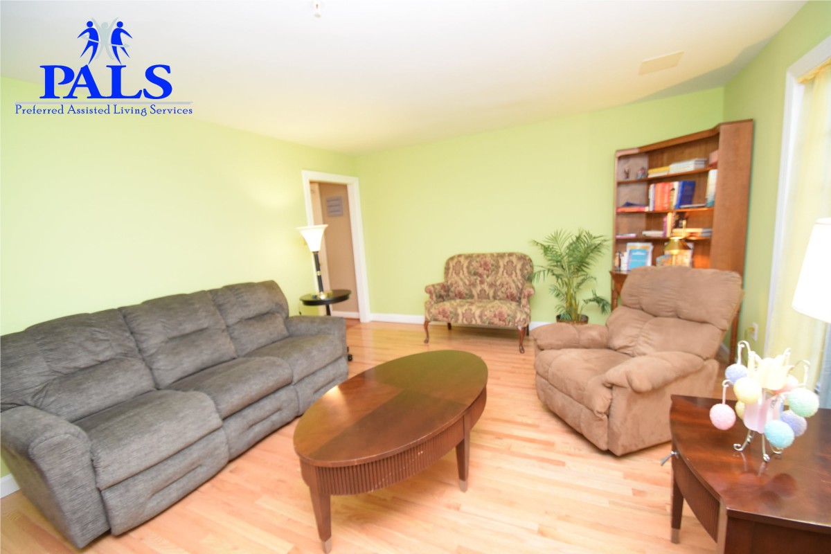 A cozy living room with comfortable seating and a bookshelf.