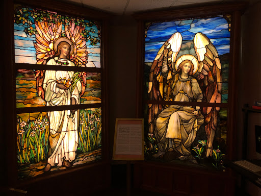 Beautiful stained glass windows depicting angelic figures and nature.
