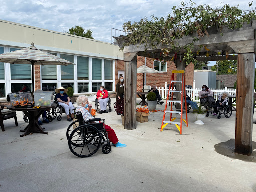Residents engaging in a community activity outside a care facility.