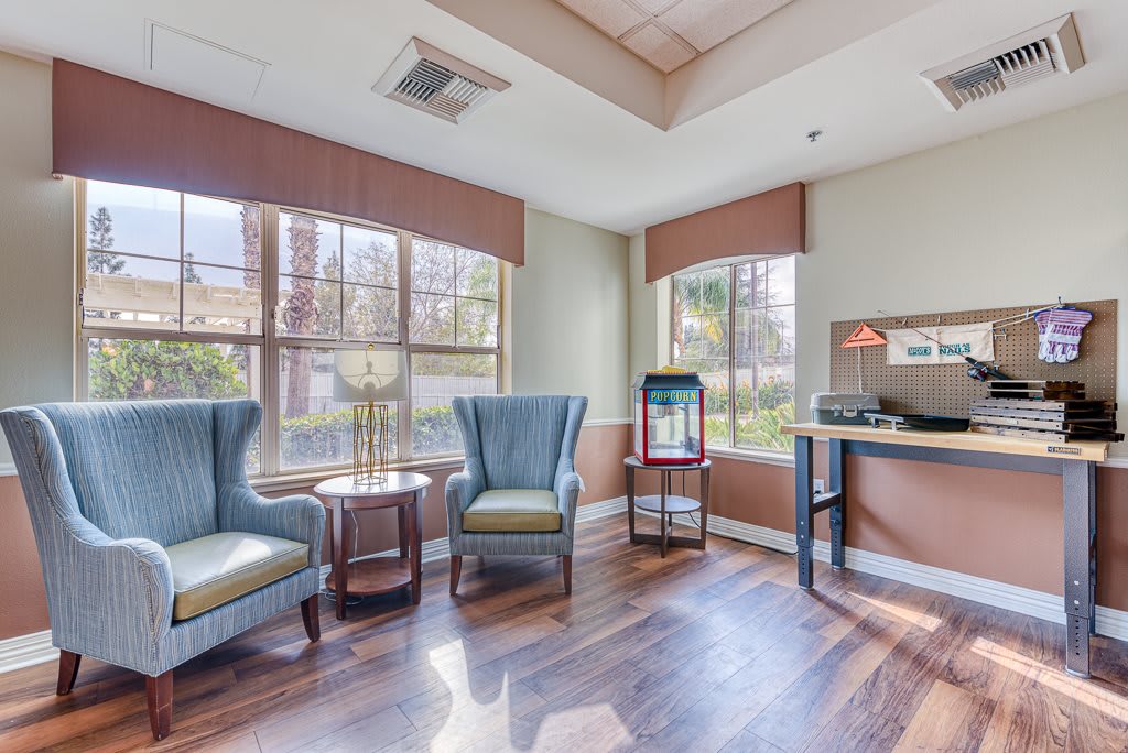 A bright and welcoming waiting room with comfortable seating and large windows.
