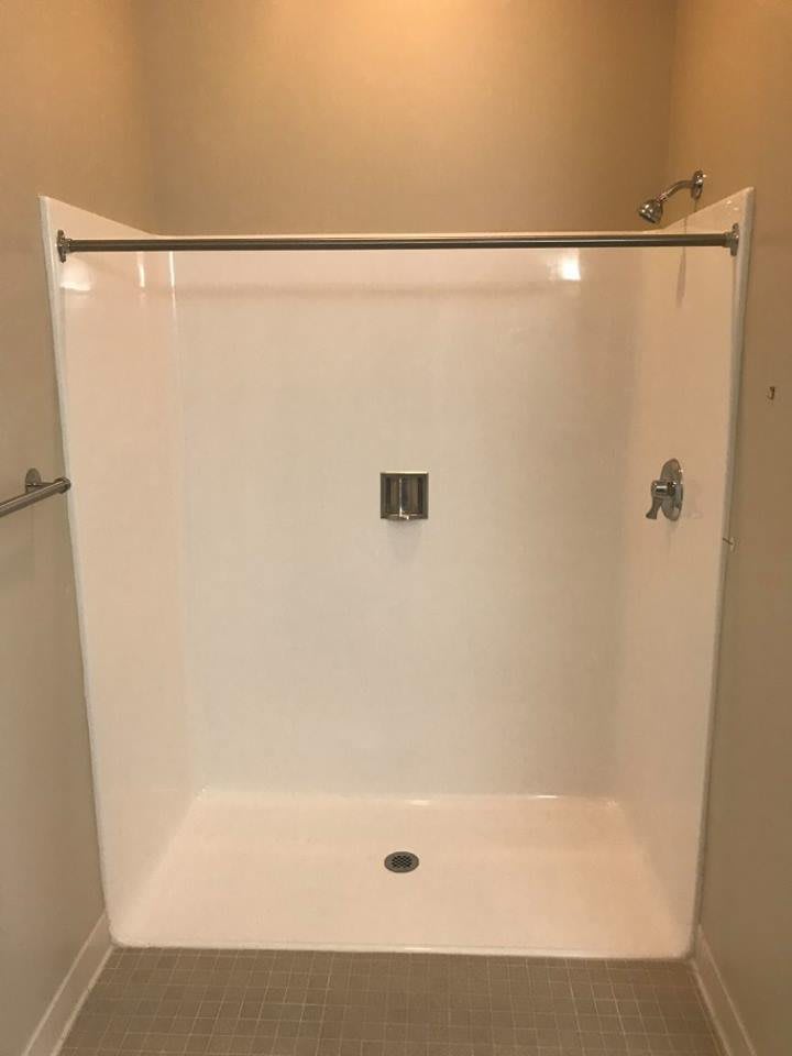 A minimalist shower with a clean, white design.