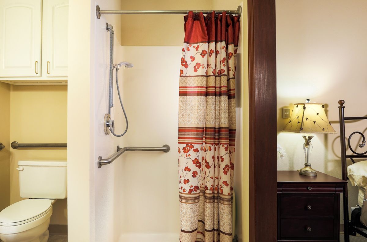 A bathroom featuring a shower with a decorative curtain.