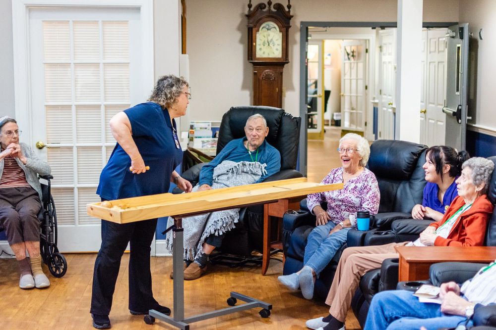 A group of elderly individuals enjoying a social activity together in a community center.