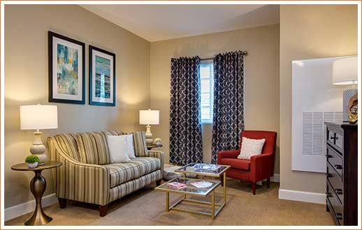 Cozy living room with a striped sofa, red armchair, and elegant decor.