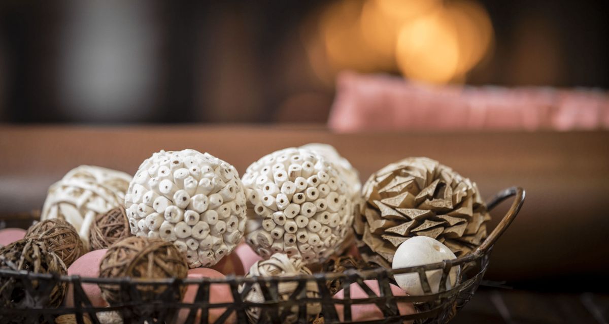 A basket filled with decorative natural ornaments, adding a rustic touch to the home decor.