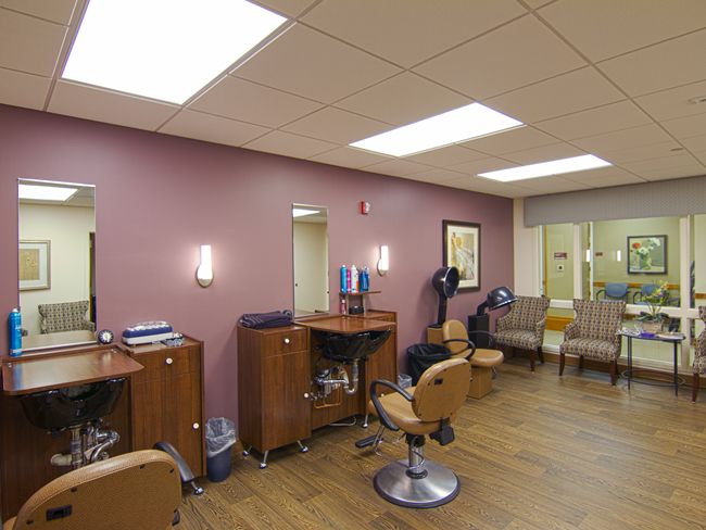 A well-lit and organized salon interior with styling chairs and a waiting area.