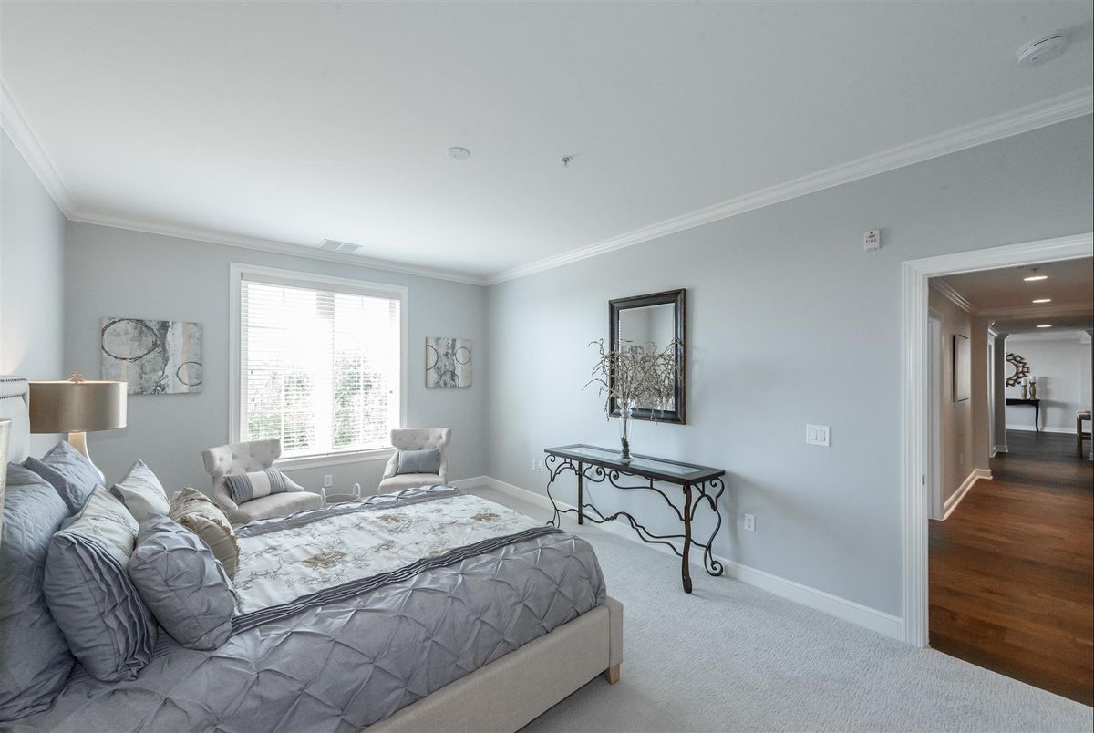 A modern minimalist bedroom with natural light and stylish decor.