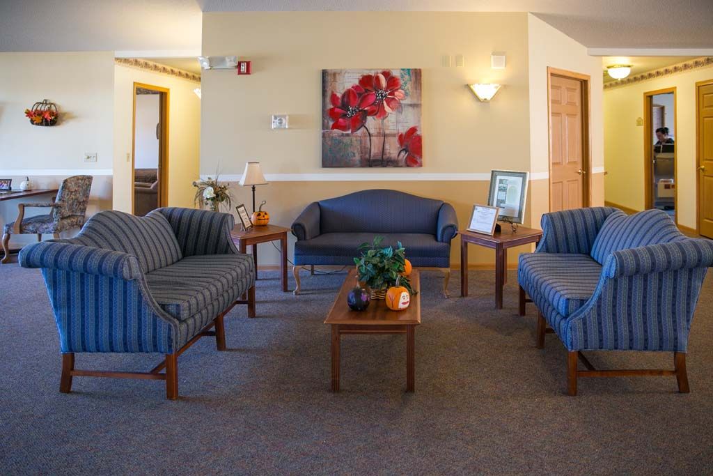 A cozy waiting room with comfortable seating and warm decor.