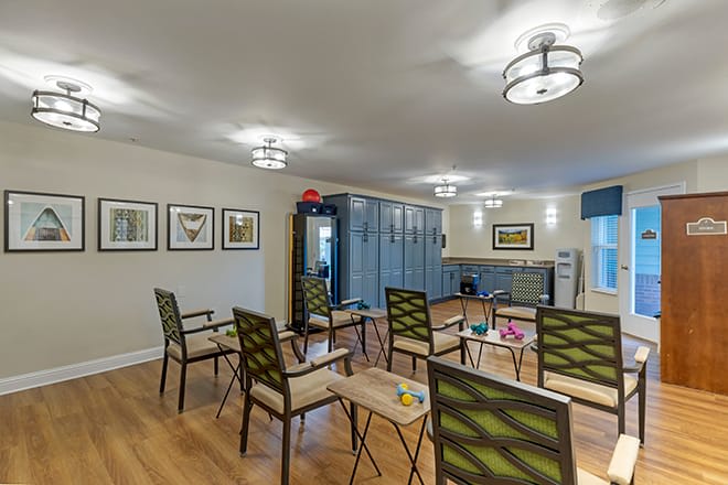 A modern meeting space with arranged chairs and artwork on the walls.