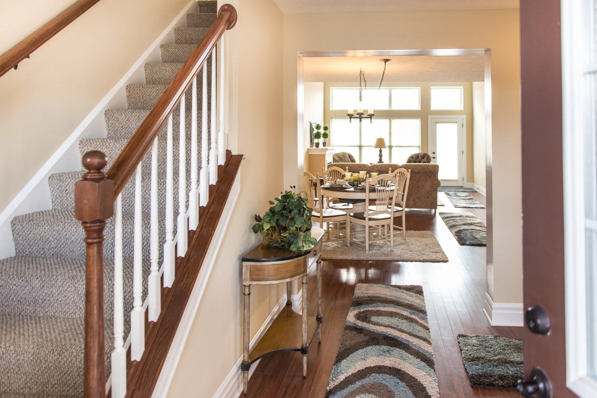 Bright and inviting home interior with a view of the dining area from the hallway.