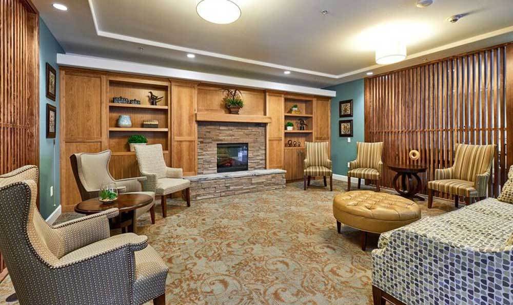 A cozy living room with a fireplace and comfortable seating area.