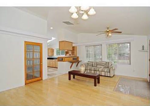 Spacious living room with hardwood floors and open layout.