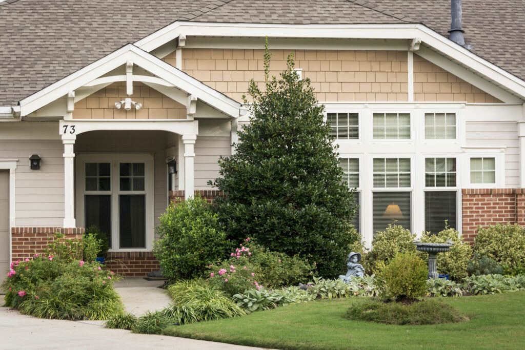 A well-maintained suburban home with a lush garden and manicured landscape.
