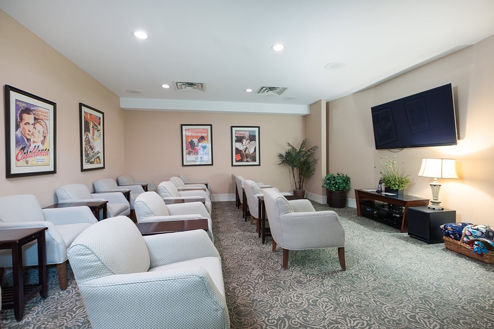 A modern lounge area with comfortable seating and a large television.
