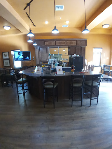 A cozy and inviting bar area with wooden finishes and warm lighting.