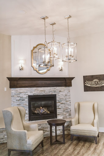A stylish and inviting living room featuring a contemporary fireplace, elegant light fixtures, and comfortable seating.