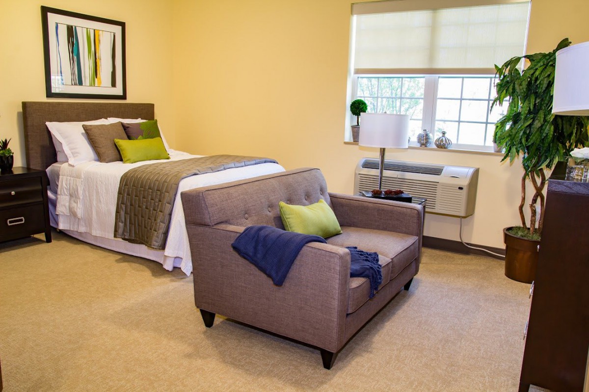 A modern bedroom with a cozy sofa and stylish decor.