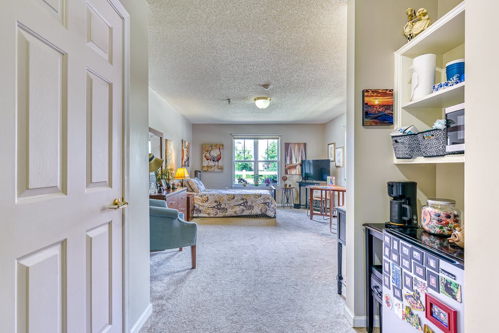 A cozy living room with comfortable furnishings and a large window providing natural light.