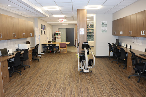 A spacious and well-lit office workspace featuring modern furniture and a cozy atmosphere.