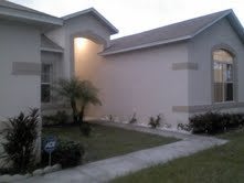 Exterior view of a residential house with a well-maintained lawn.