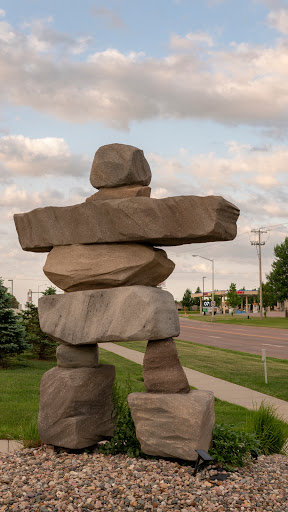 A large stone sculpture resembling an Inukshuk, symbolizing friendship and guidance.