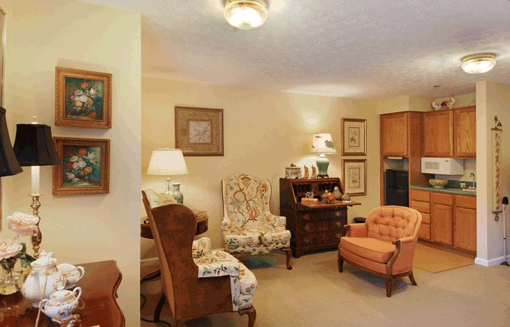A cozy living room with vintage furniture and warm lighting.