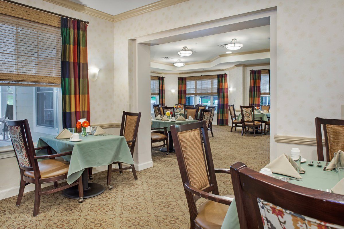 A view of a well-lit dining area with neatly arranged tables and chairs.