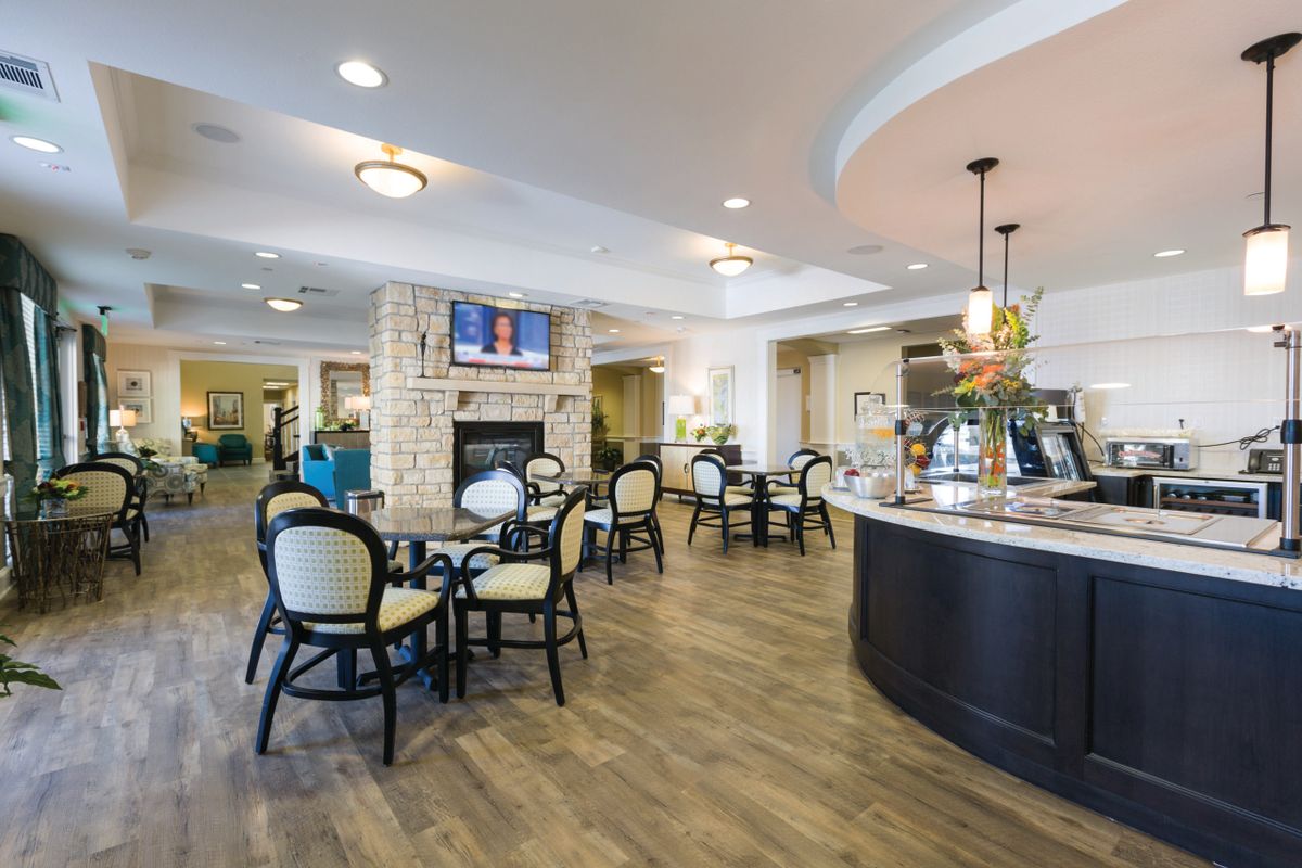 A modern cafe interior with seating and a counter.