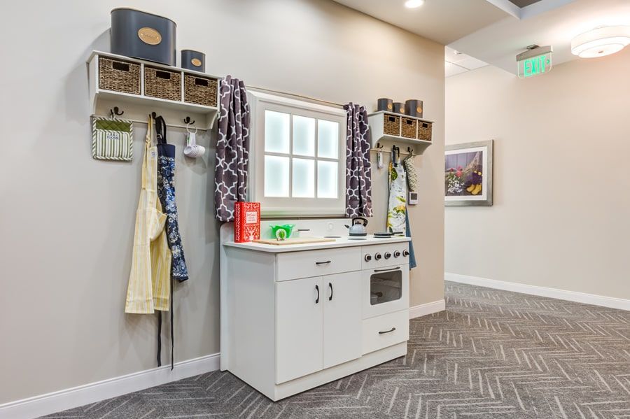 A children's play kitchen setup with various toys and colorful decor.