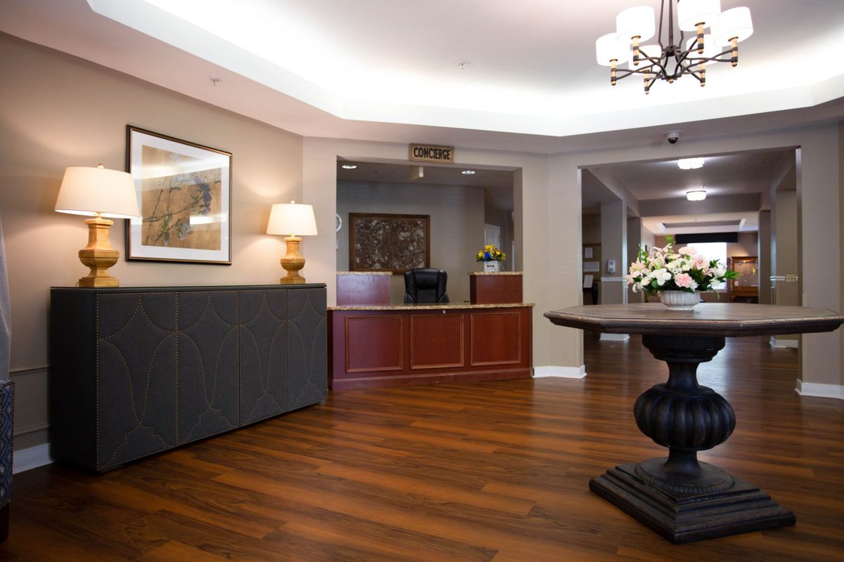 A modern lobby with a wooden floor and stylish reception area.