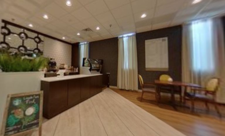 A modern office meeting room with a table, chairs, and refreshments.