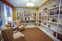 A cozy reading room with bookshelves and comfortable chairs.