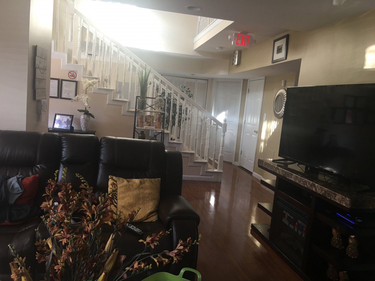 A cozy living room space with a staircase and modern decor.