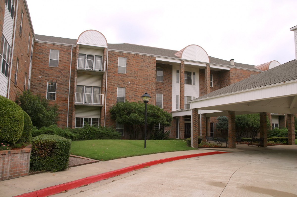 A residential apartment building with a landscaped entrance.