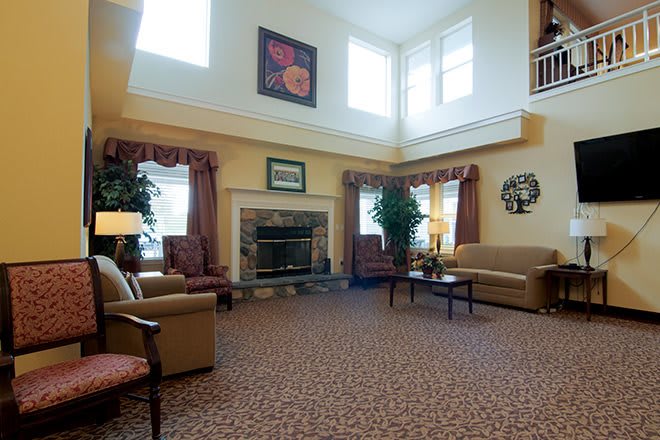 A spacious living room with comfortable seating and a fireplace.