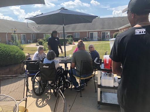 Residents enjoying a sunny day together at an outdoor gathering.