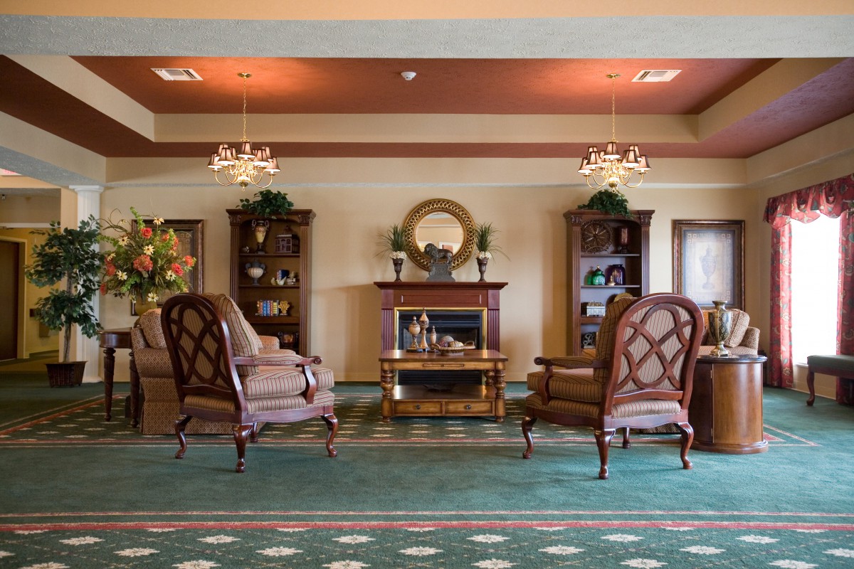 Elegant living room with classic furniture and a cozy fireplace.
