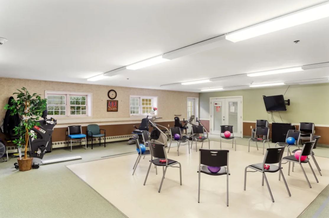 An empty community meeting room with chairs arranged in a circle.