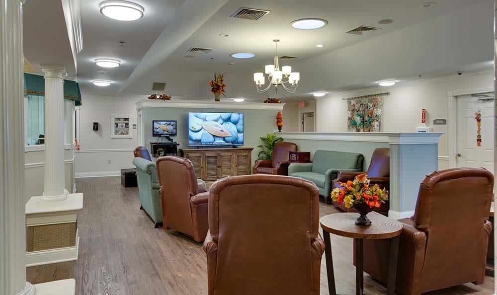 A cozy living room with comfortable seating and a large television.