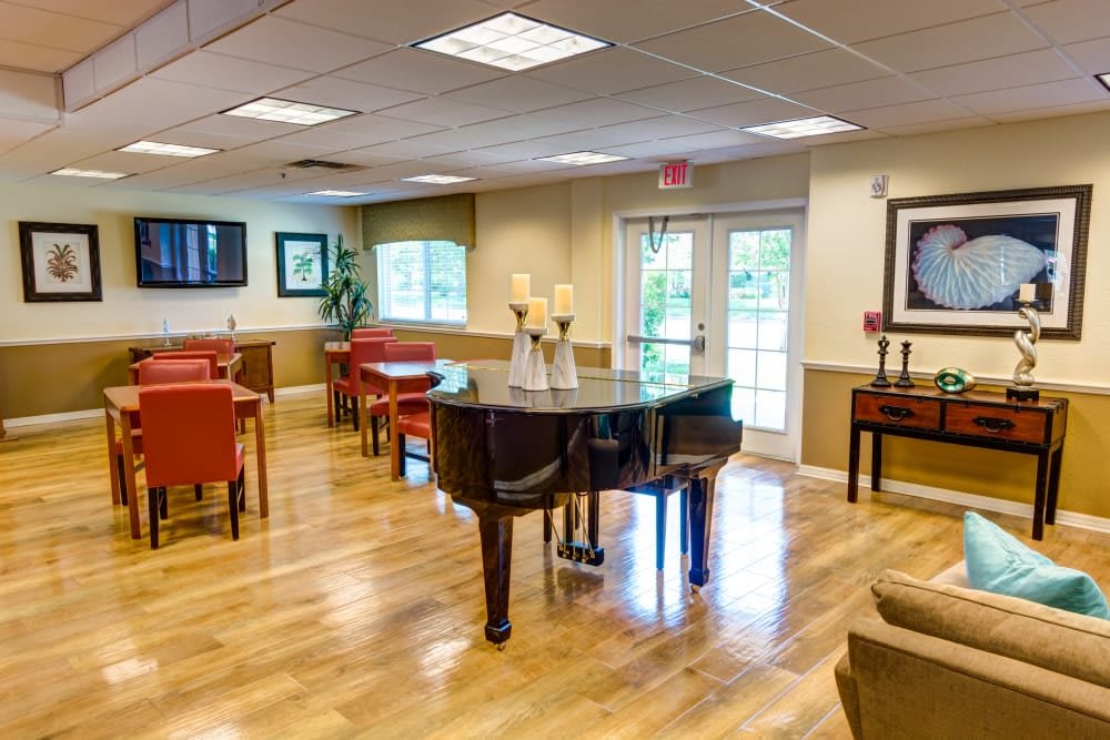 A cozy interior with a grand piano and comfortable seating.