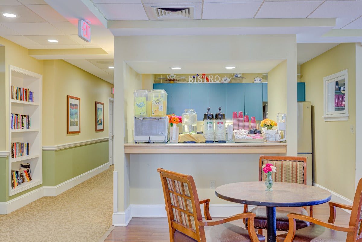 A cozy cafe interior with a seating area and a view of the service counter.
