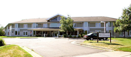 A cozy residential building with a welcoming front entrance and parking area.