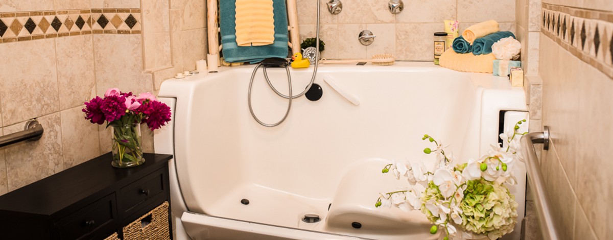 A cozy bathtub in a bathroom setting, complete with a showerhead and decorative elements.