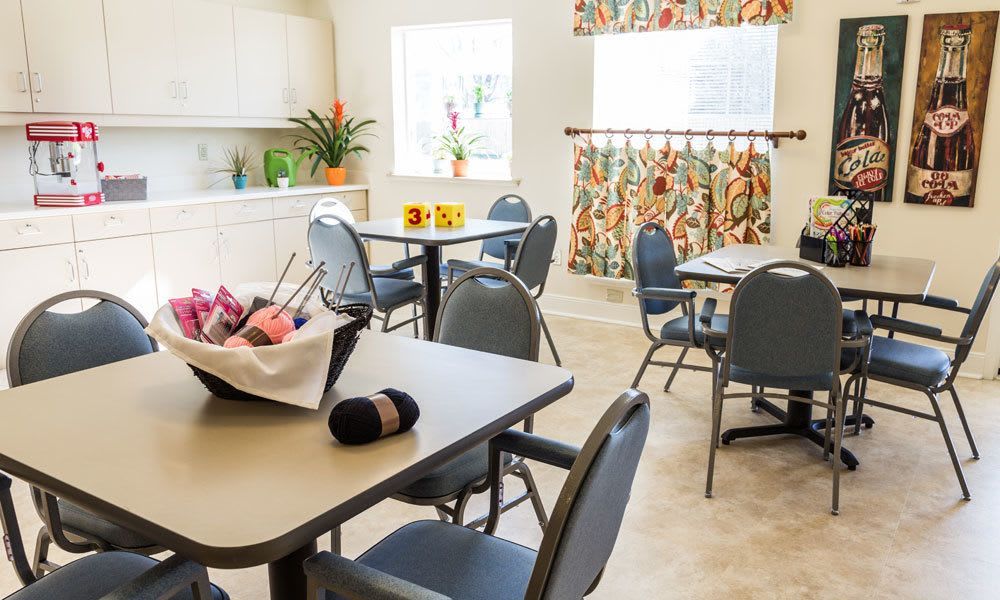 A bright and clean dining area with neatly arranged tables and chairs, adorned with colorful decor.