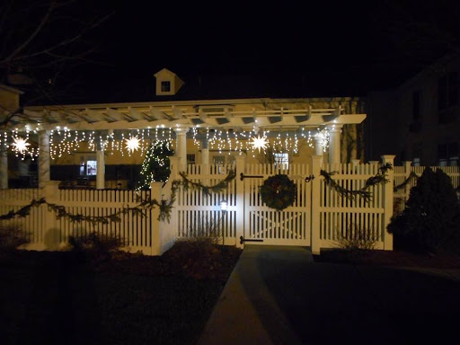 A beautifully decorated house illuminated with holiday lights, creating a festive atmosphere at night.