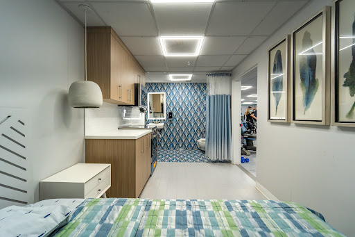 A modern hospital patient room featuring contemporary design elements and a clean aesthetic.